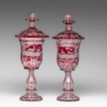 A near pair of Bohemian glass red overlay goblets with etched decoration of hunting scenes, 19thC, H