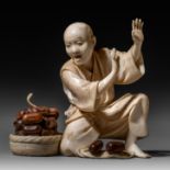 A Japanese ivory okimono of a man scared of a snake coming from his basket, Meiji period, H 8,3 cm -
