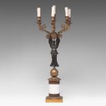 An Empire style patinated and gilt bronze caryatid candelabra on a marble base, H 89 cm