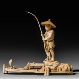 A Japanese ivory okimono depicting a fisherman, signed Seishu, H 14,5 cm (without the rod) - W 18,4