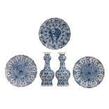 A collection of three blue and white Delft chargers and a pair of bottle vases, 18thC, dia 35 - H 38