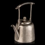 A Japanese inspired pewter tea pot with an ebonised wooden handle, marked Hutton Sheffield, reg. no.