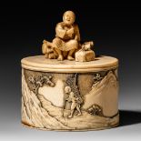 A lovely Japanese Meiji period oval-shaped ivory box and cover decorated with an allegory on winter,