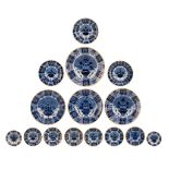 A collection of 15 blue and white peacock Delft dishes, 18thC, dia 34,5 cm
