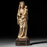 A mammoth ivory sculpture depicting the Holy Virgin and child, early 20thC, H 38,5 cm (base incl.) -