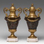 A pair of Neoclassical gilt and patinated bronze cassolettes, decorated with putti, H 48,5 cm