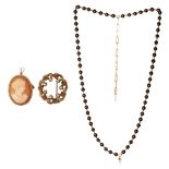 A various collection of a circular-shaped brooch, a cameo brooch and a pearl necklace