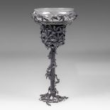 An Interwar Period wrought iron fountain with floral decoration and glass top, H 120 - dia 58 cm