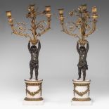 A pair of Neoclassical gilt and patinated bronze figural candelabras on marble bases, 19thC, H 65 cm