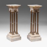 A pair of Neoclassical four-column onyx pedestals with gilt brass mounts, H 117 cm