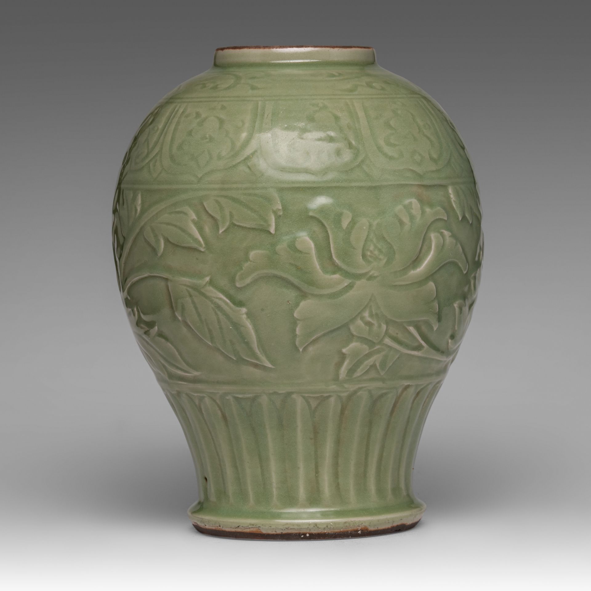 A Chinese carved Longquan celadon 'Peony' jar, Ming dynasty, H 32,5 cm