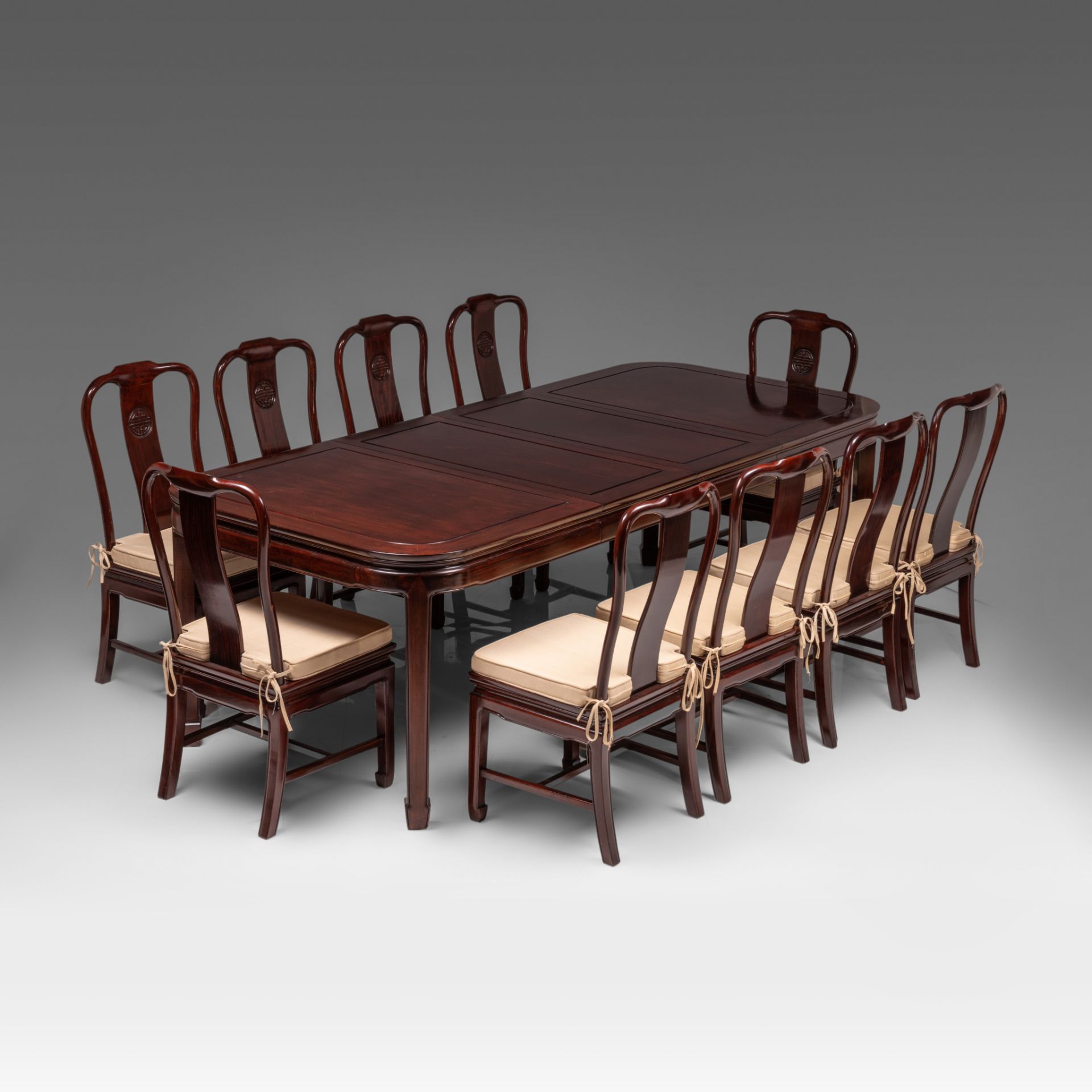 A Chinese rosewood dinner ensemble: dinner table (incl. extend) and ten chairs, 20thC, H 76 - 240 x
