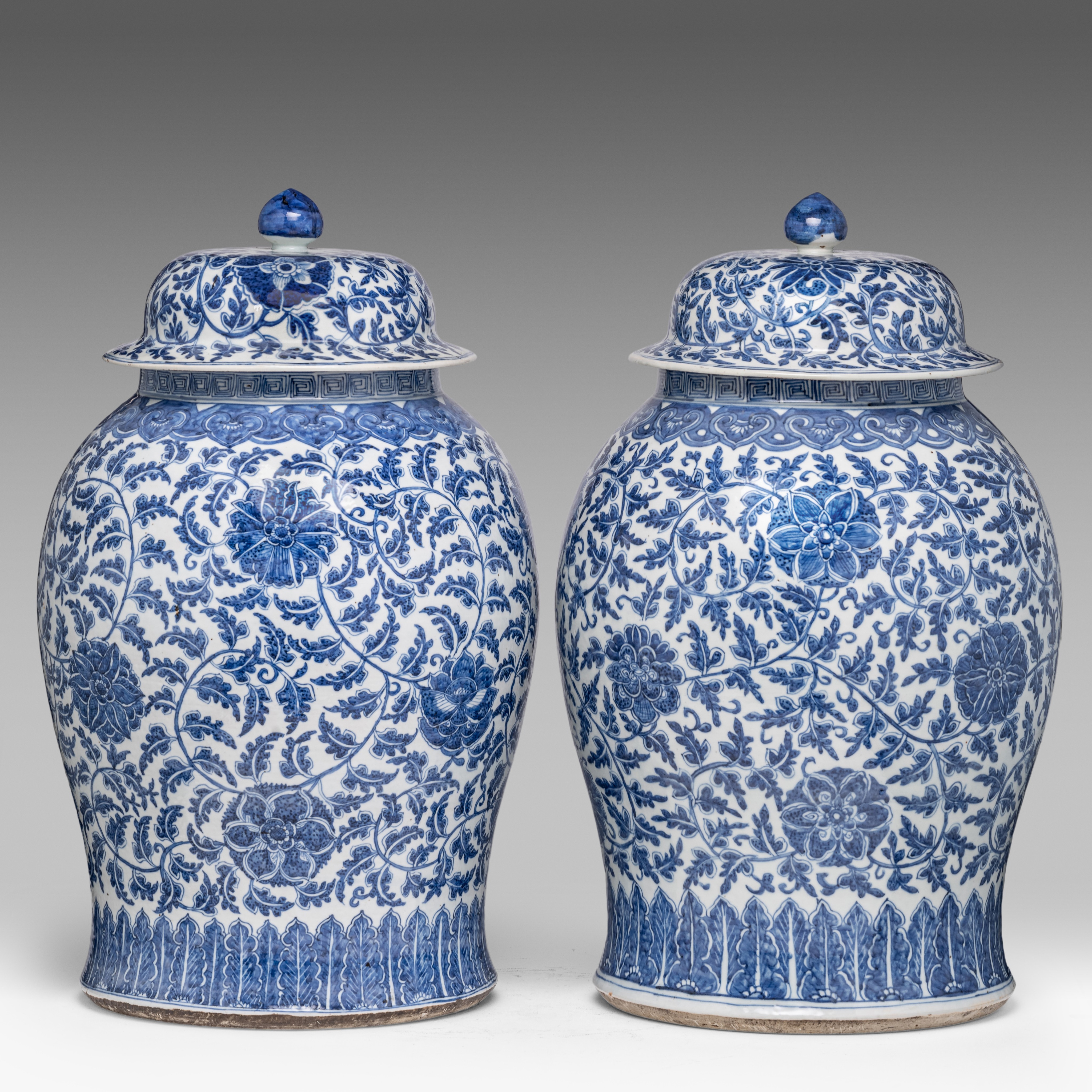 A pair of Chinese blue and white 'Scrolling Lotus' baluster vases and covers, 19thC, H 61,5 cm