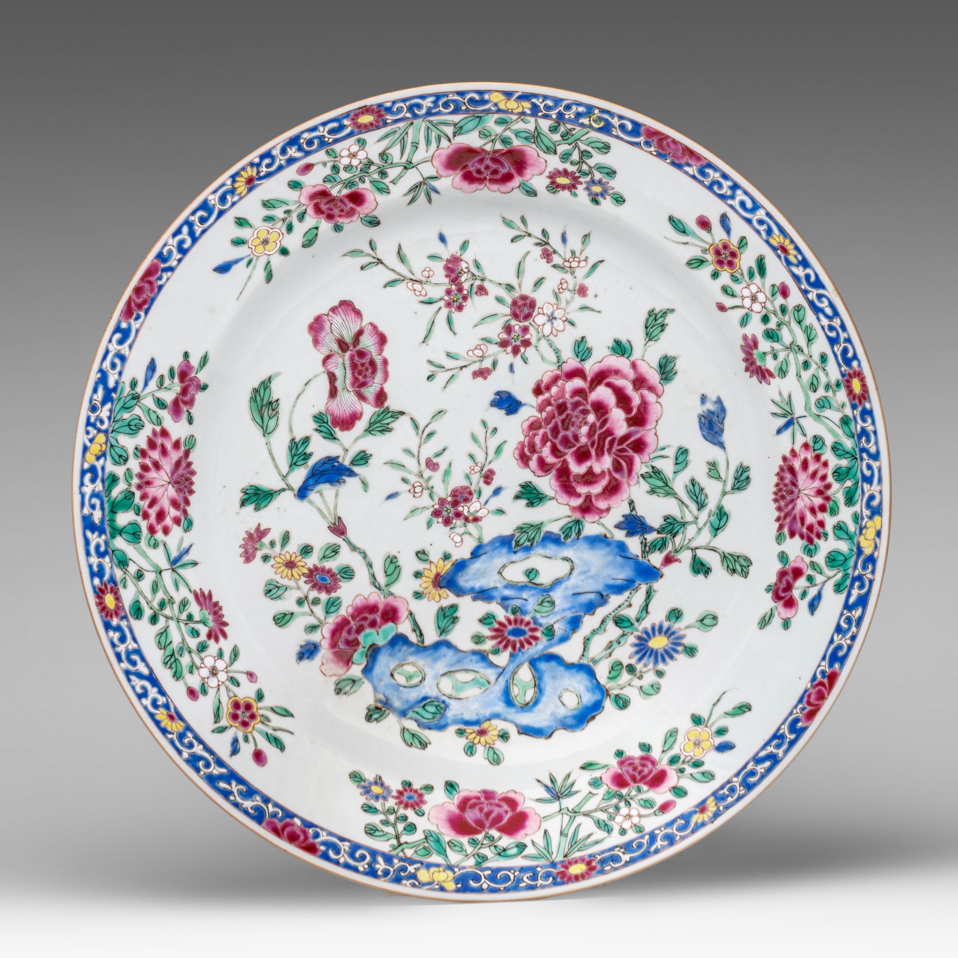 A Chinese famille rose 'Poeny garden' export porcelain charger, Yongzheng/Qianlong period, dia 38 cm