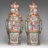 A pair of Chinese Canton famille rose baluster vases and lids, 19thC, H 65 cm
