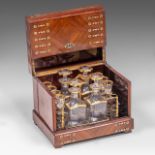 A Napoleon III mahogany veneered liquor cellar, with gilt decorated cut crystal glasses and carafes,