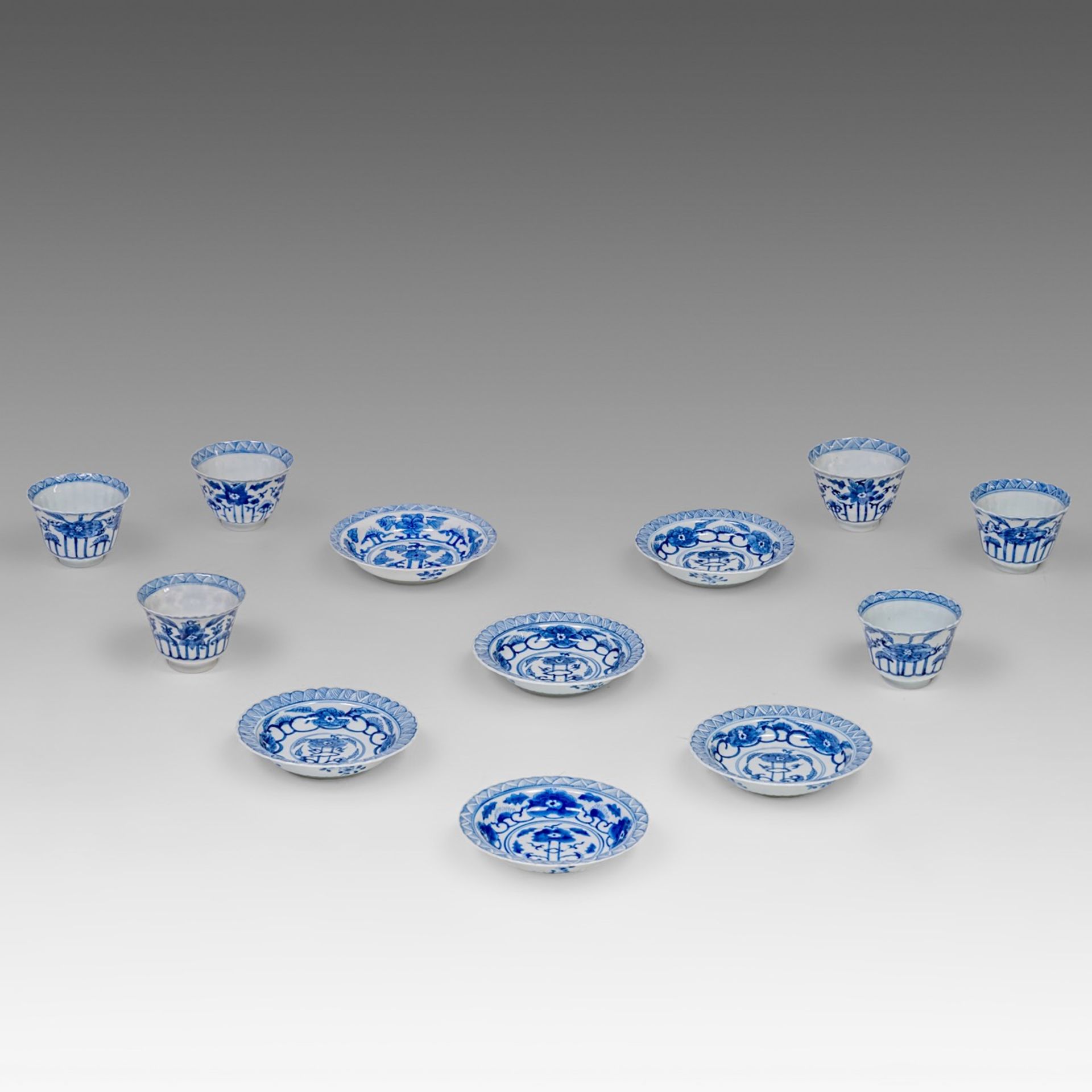 Six matching sets of Chinese blue and white floral decorated tea cups and saucers, Kangxi period, di