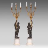 A pair of figural candelabras, gilt and patinated bronze on Carrara marble, after Clodion, H 94 cm