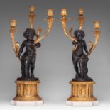 A pair of Neoclassical gilt and patinated bronze figural candelabras, H 61 cm