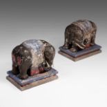 A pair of South-Chinese polychrome painted wooden models of caparisoned elephants, standing on a mat