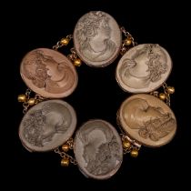 A Victorian lava cameo bracelet in gilt metal mount, L 18,5 cm, and two oval cornelian shell cameos,