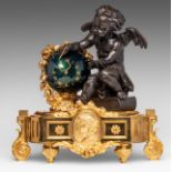 A Neoclassical gilt and patinated bronze mantle clock with a putto and a globe, H 55 - 55 W cm