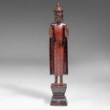 A Laos lacquered wooden figure of standing Buddha, late 19thC, Total H 95,5 cm