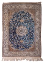 A Persian Nain woollen rug with a central medallion, 229 x 169 cm