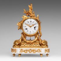 A small Louis XVI gilt bronze mantle clock on a marble base with laurel branch decoration, the movem