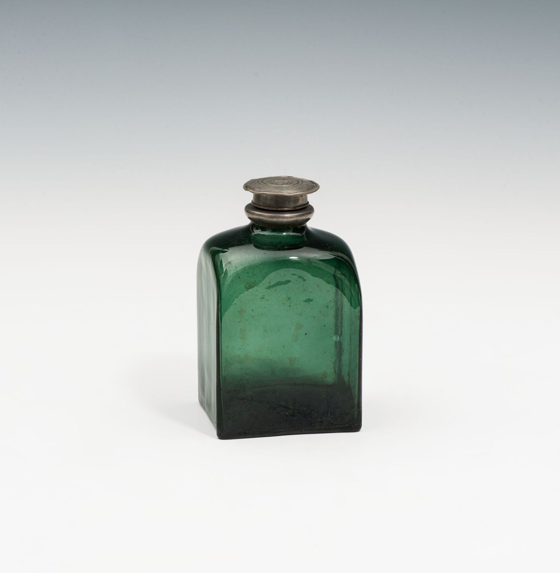 Bottle18th centurydark green glass; tearing scar at the bottom; pewter mounting with screw cap;