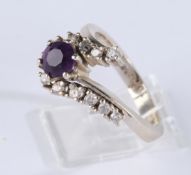 Ring, WG 585, 1 runder Amethyst ca. 5.5 mm, 12 kleine Brillanten zus. ca. 0.25 ct., 4.4 g, RM 17