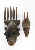 2 Masken, Bamana, Mali, Afrika, Holz, 1x mit Messingblech und roten Quasten, 40-62 cm hoch, 1x mit 