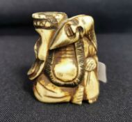 NETSUKE: MANN MIT KORB