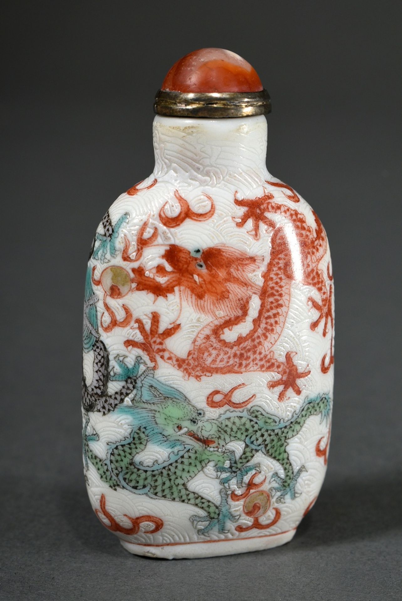 Fine porcelain snuffbottle with five "5-toed celestial dragons with flaming pearls" and waves sgraf