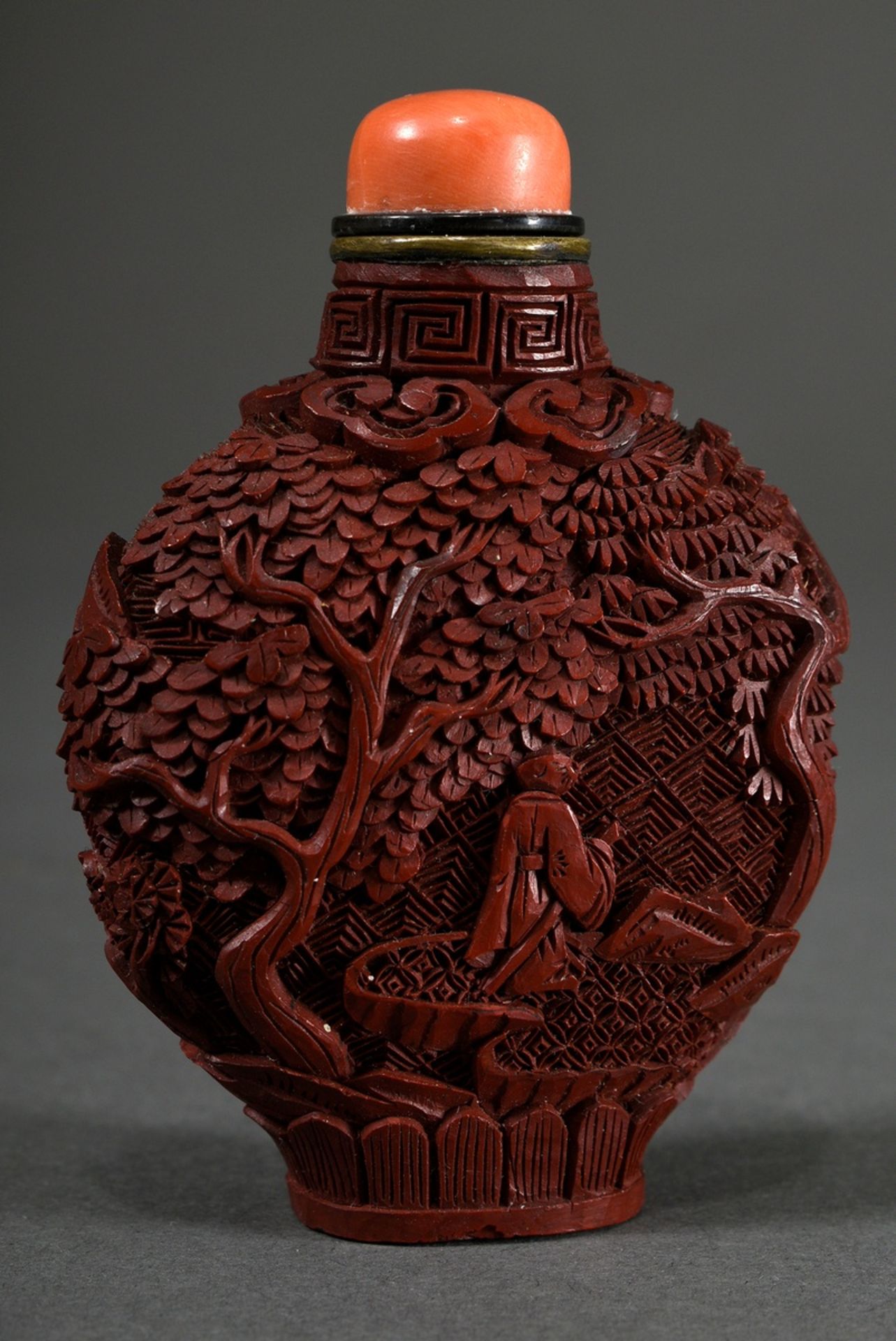 Red carved lacquer snuff-bottle "Landscape and Garden Scenes" in deep relief, stopper with coral ca - Image 2 of 4