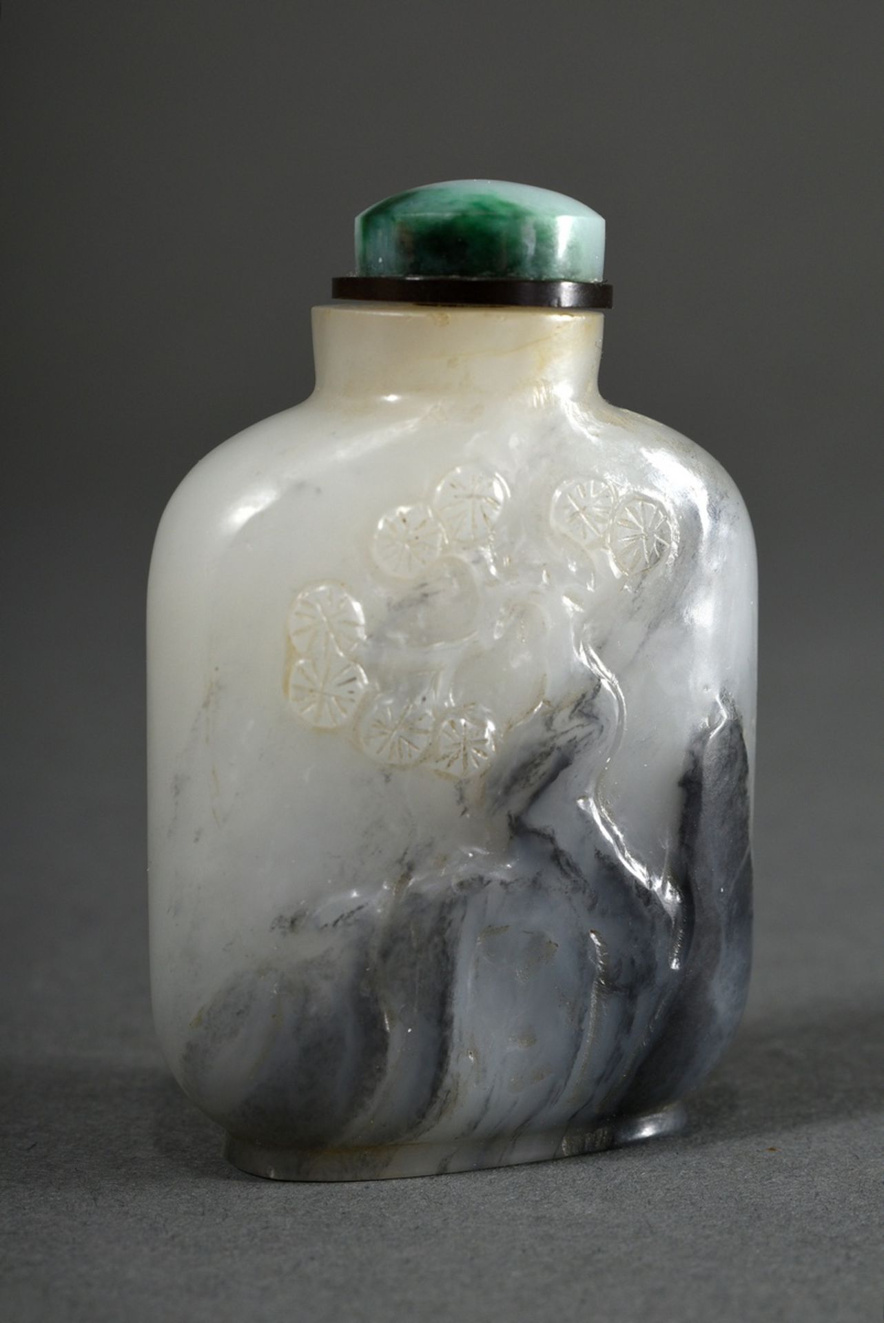 Grey jade snuffbottle "rock and pine" in high relief in white and grey, well hollowed, China Qing D