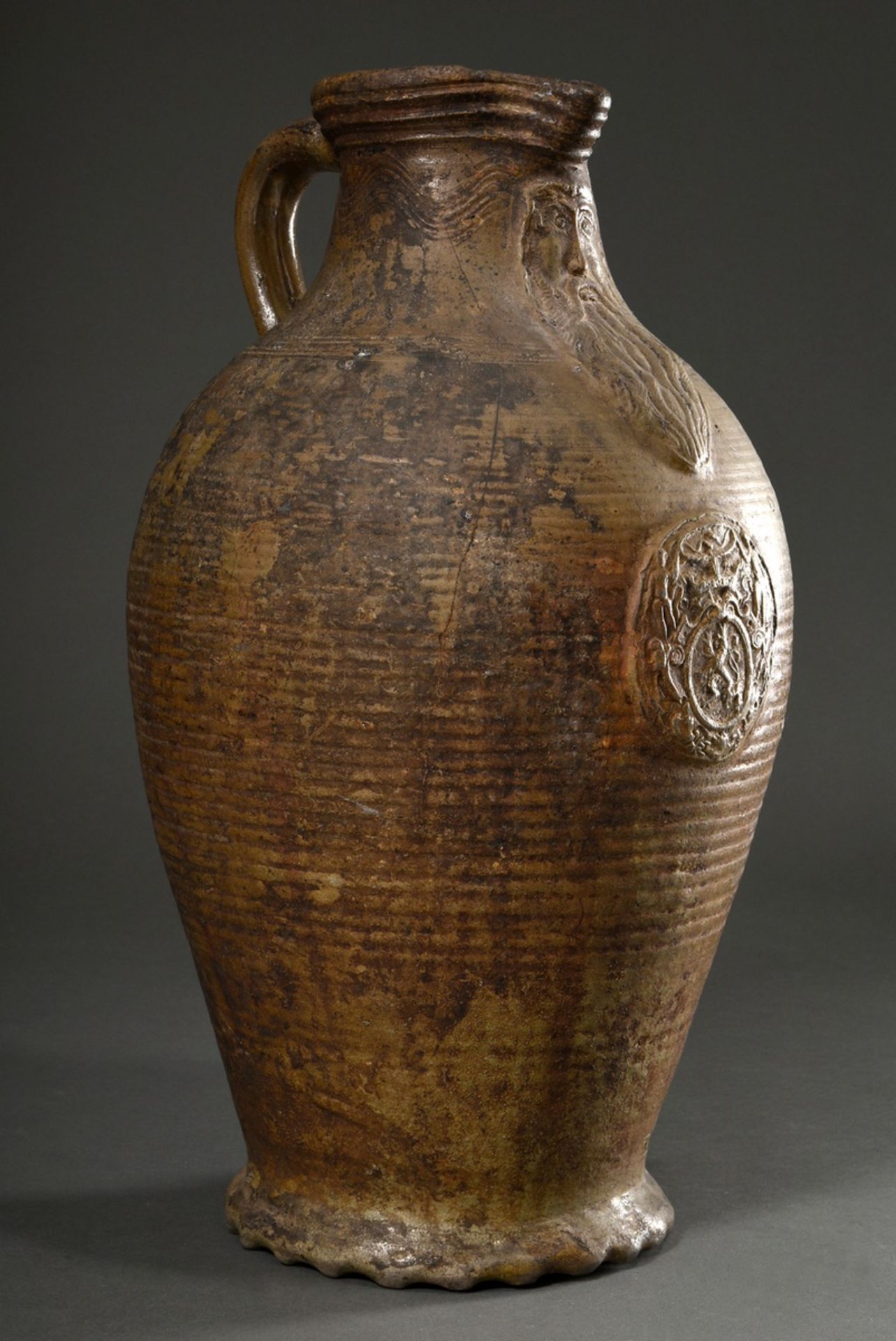 A large Pötzkanne or Bartmann jug with remnants of light brown salt glaze and "Bartmann mask" decor