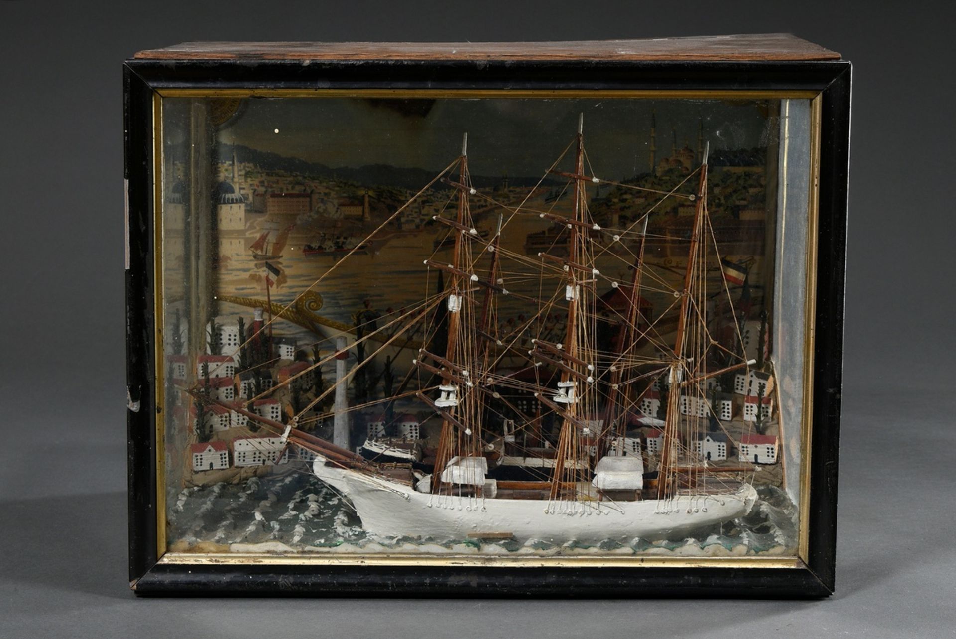 Diorama with two full ship models "three-master and two-master" in front of miniature town, back wa