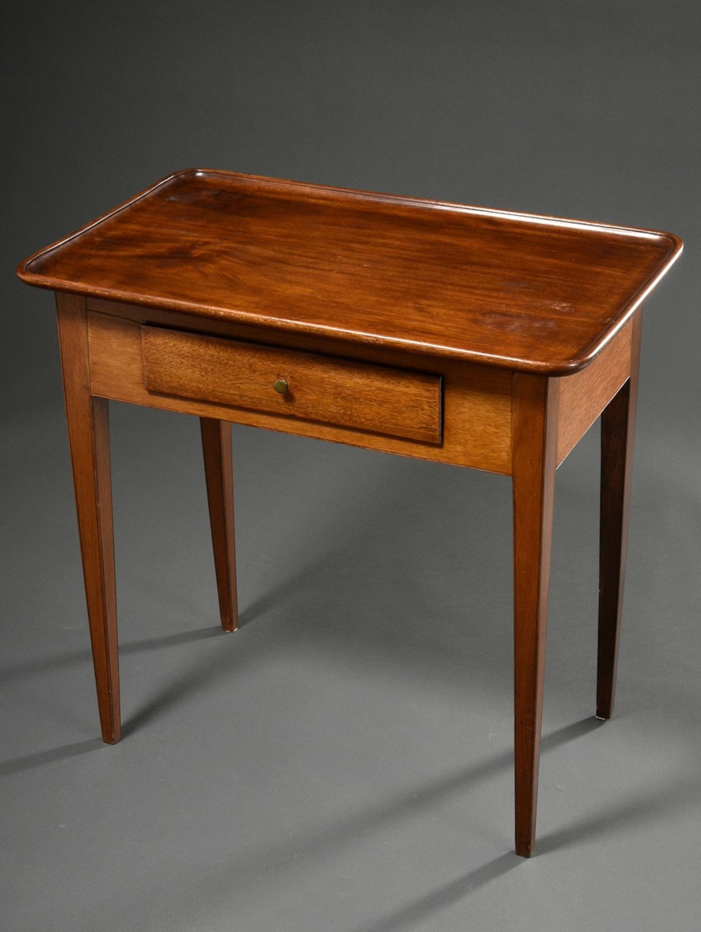 Elegant mahogany tea table with rectangular top and surrounding bead and drawer in the frame, 19th 