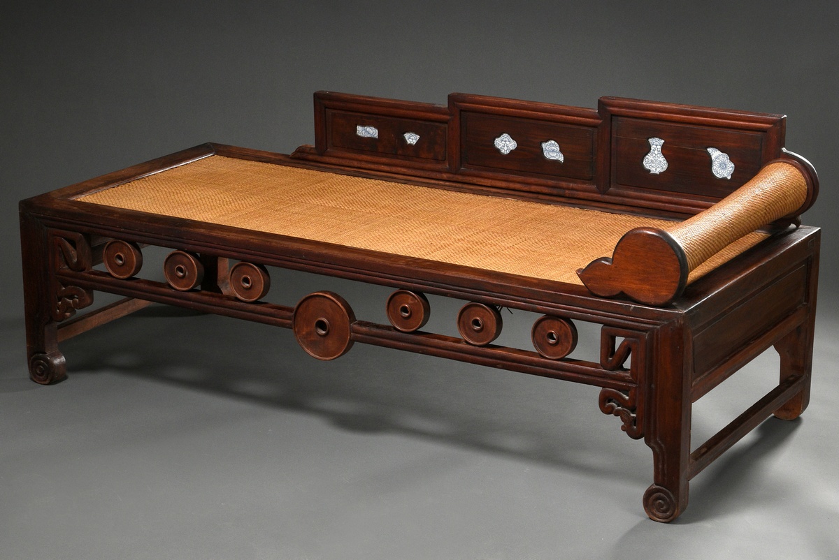Chinese opium bed with circular segments in the frame on rolled legs with woven lying surface and b