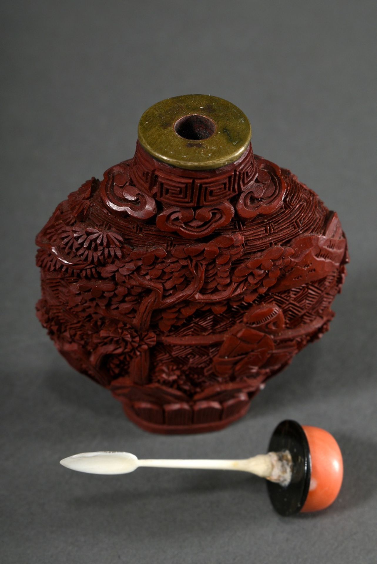 Red carved lacquer snuff-bottle "Landscape and Garden Scenes" in deep relief, stopper with coral ca - Image 3 of 4