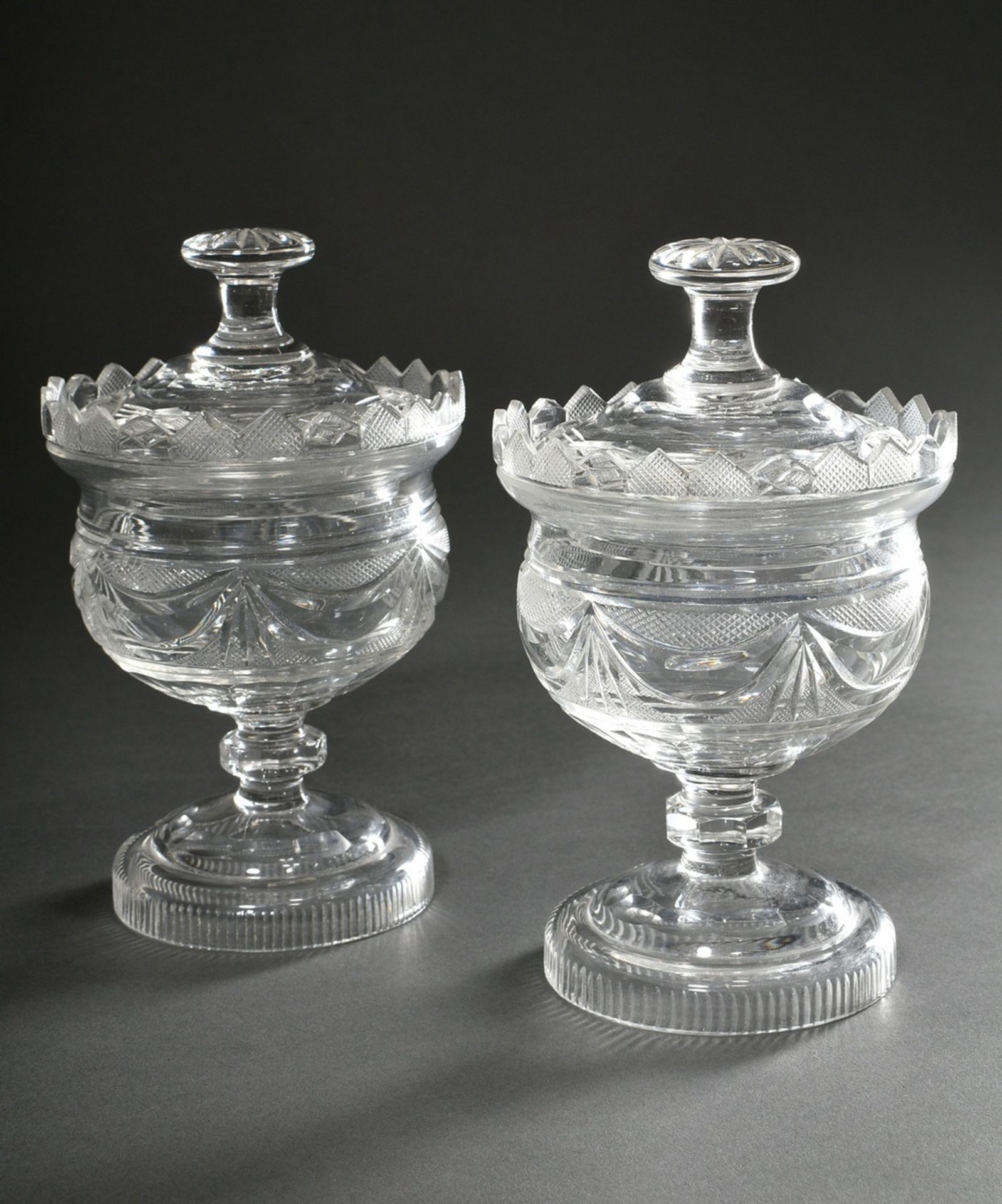 Pair of crystal lidded vessels with rich cut, garland decoration, 19th century, h. 19cm, rim crowns