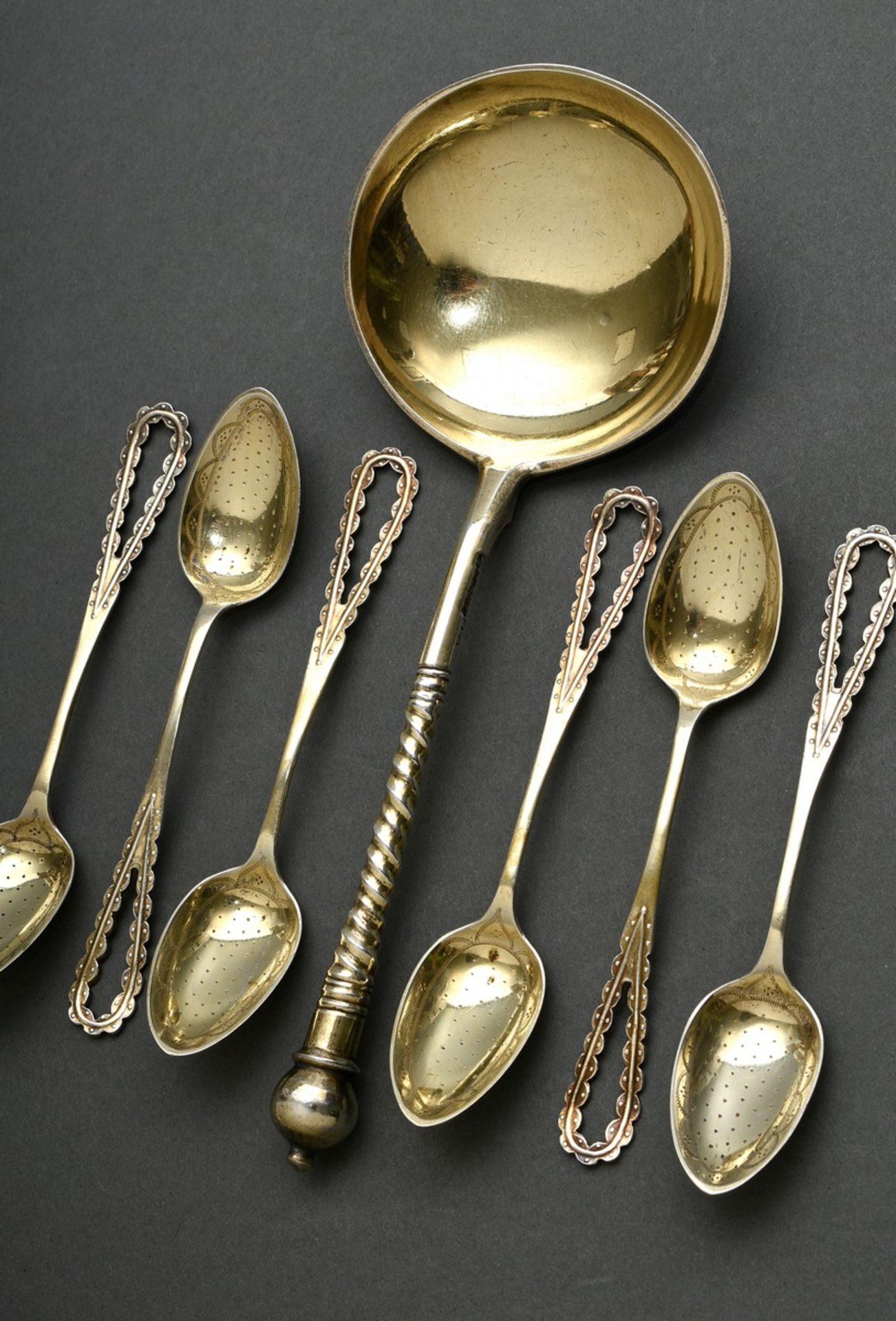 7 Various pieces of gilded cutlery, 19th century: Russian cream spoon with twisted handle and engra