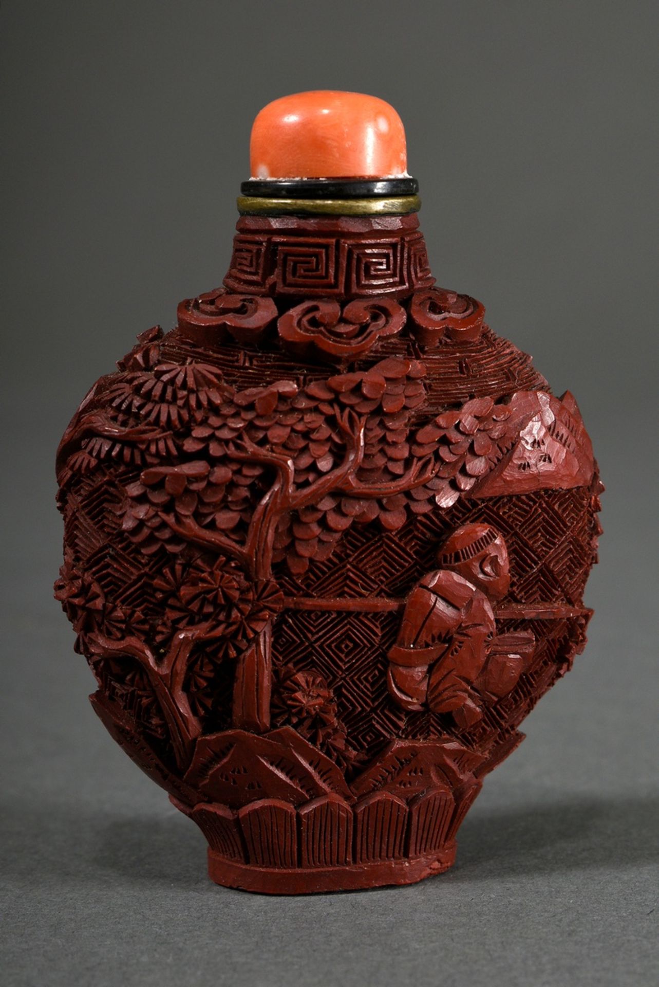 Red carved lacquer snuff-bottle "Landscape and Garden Scenes" in deep relief, stopper with coral ca