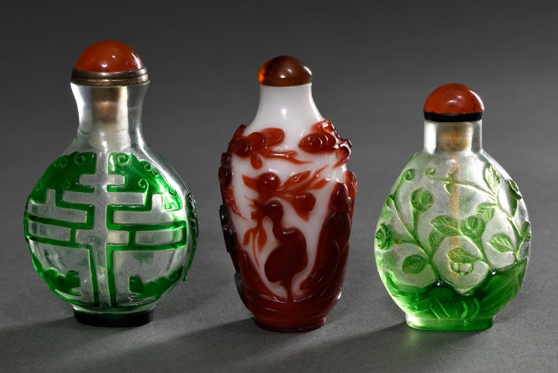 3 Various overlay glass snuffbottles: Shoulao with crane, deer, bat and spruce / Shou sign, bats an