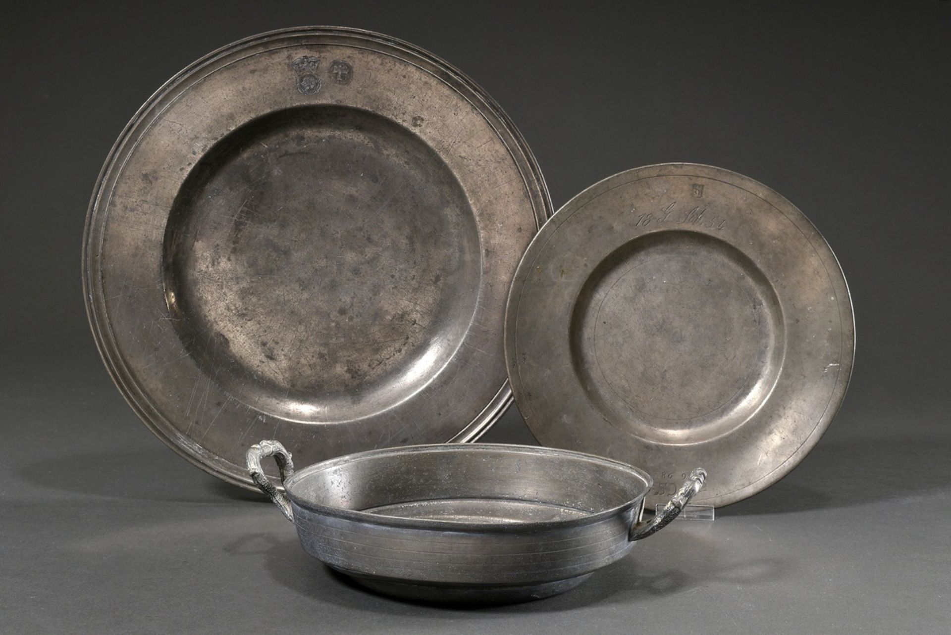 3 Various pieces of pewter: large North German wide rim plate with profiled rim, uninterpreted rose