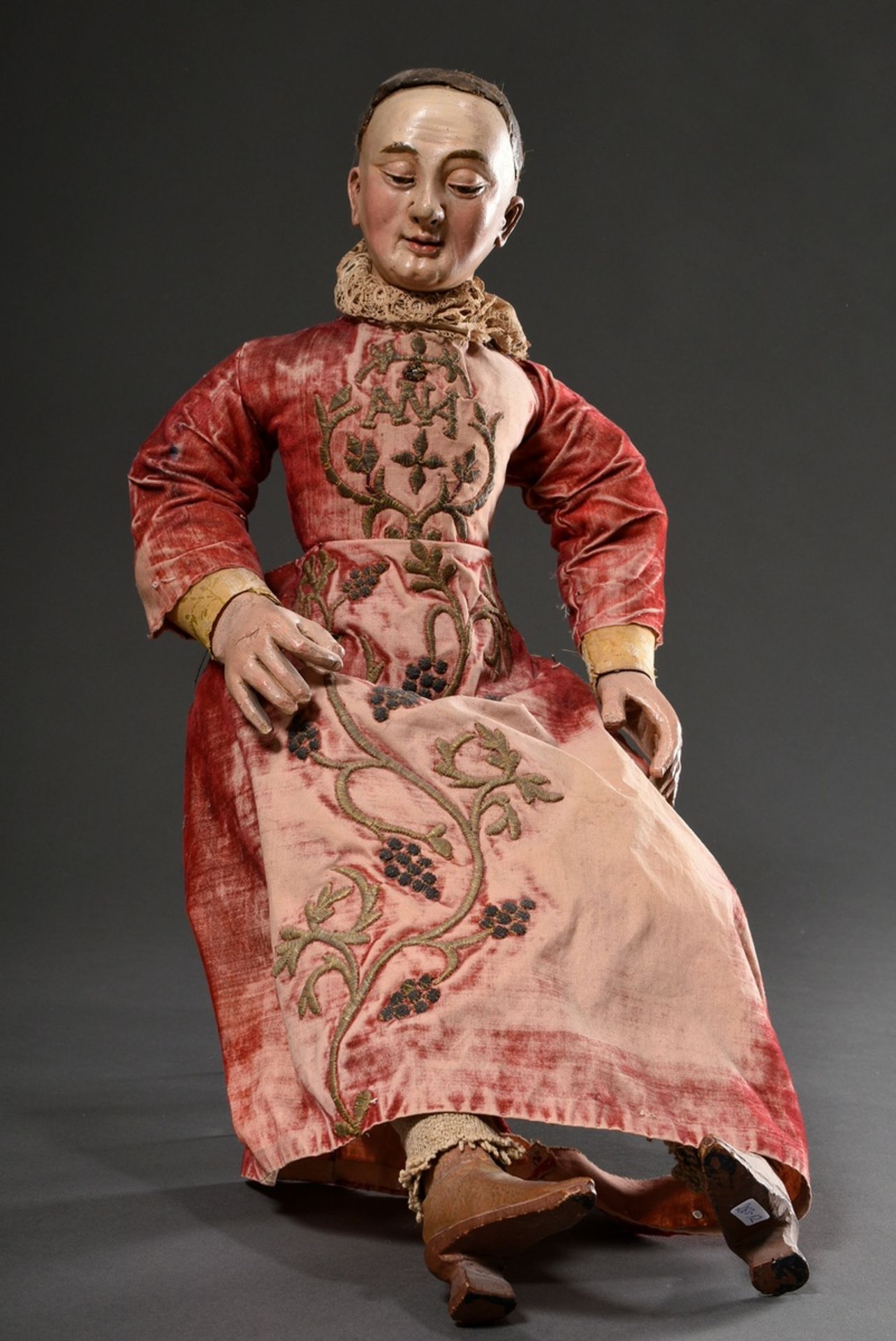 Small processional figure in original clothing with wooden/cloth body and movable limbs, hands and 