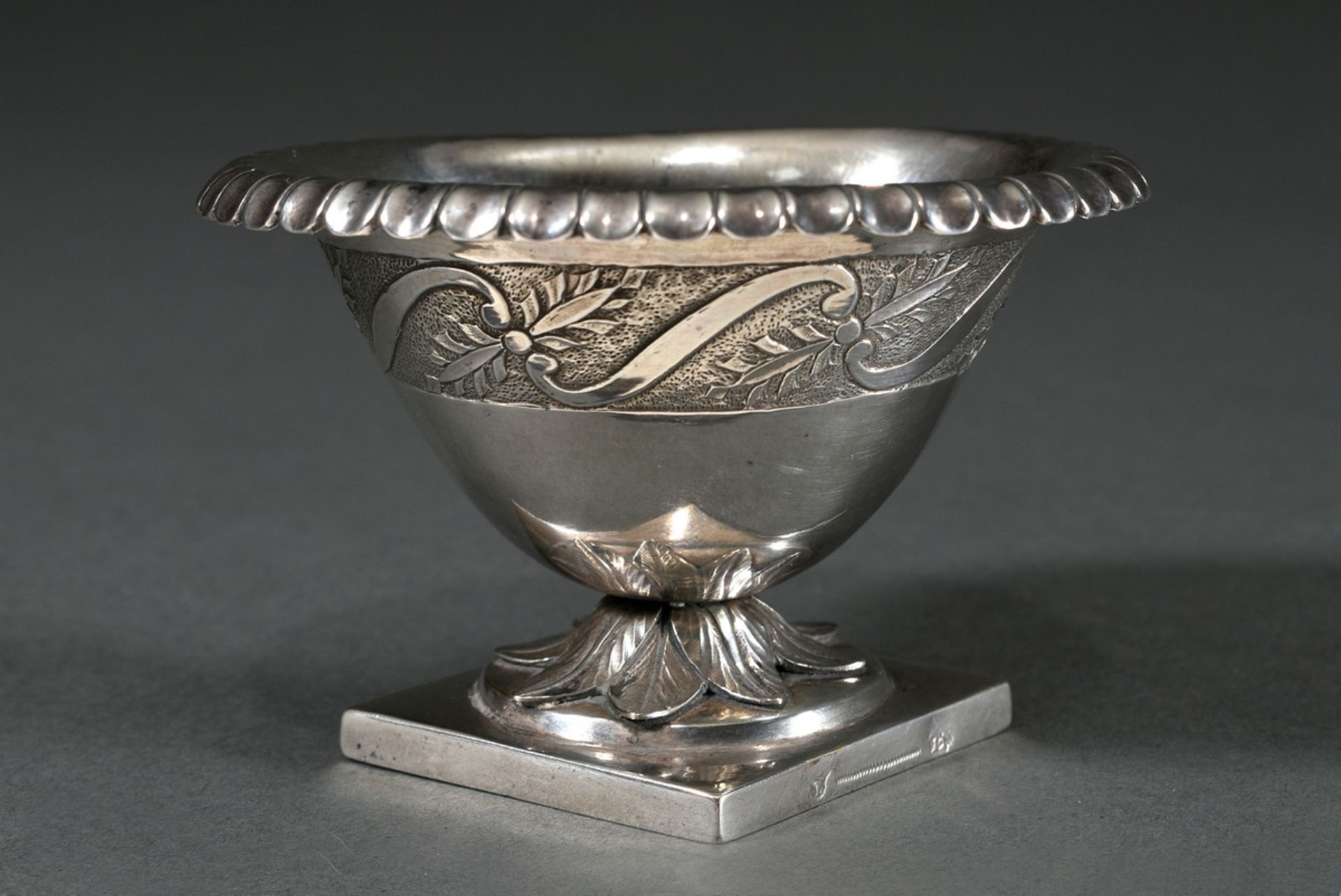 Empire salver of oval form on a diamond-shaped base with sculpted foliate rim and ornamental frieze