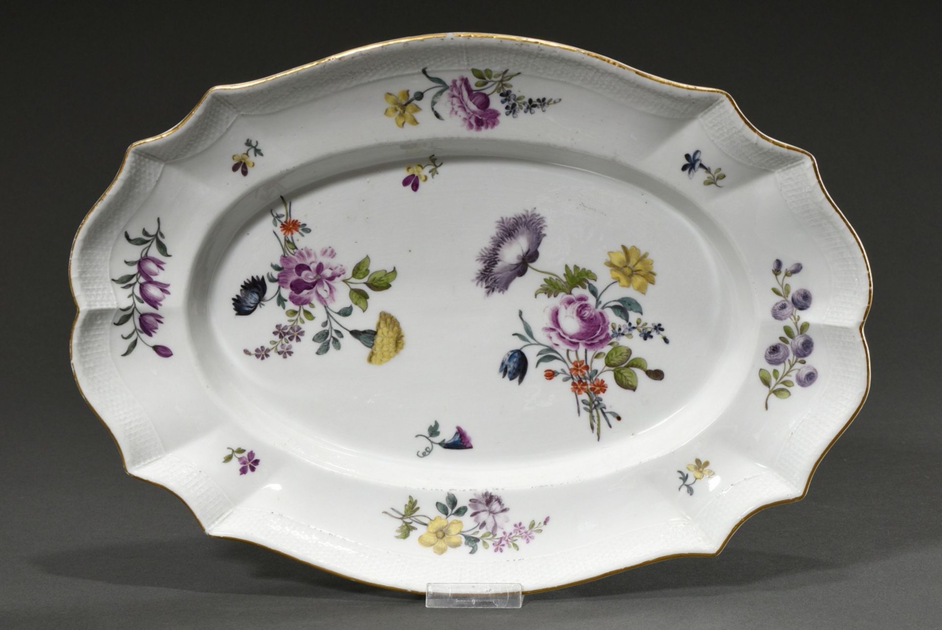 Oval Meissen plate with polychrome floral painting and basket relief as well as gold rim, 18th cent