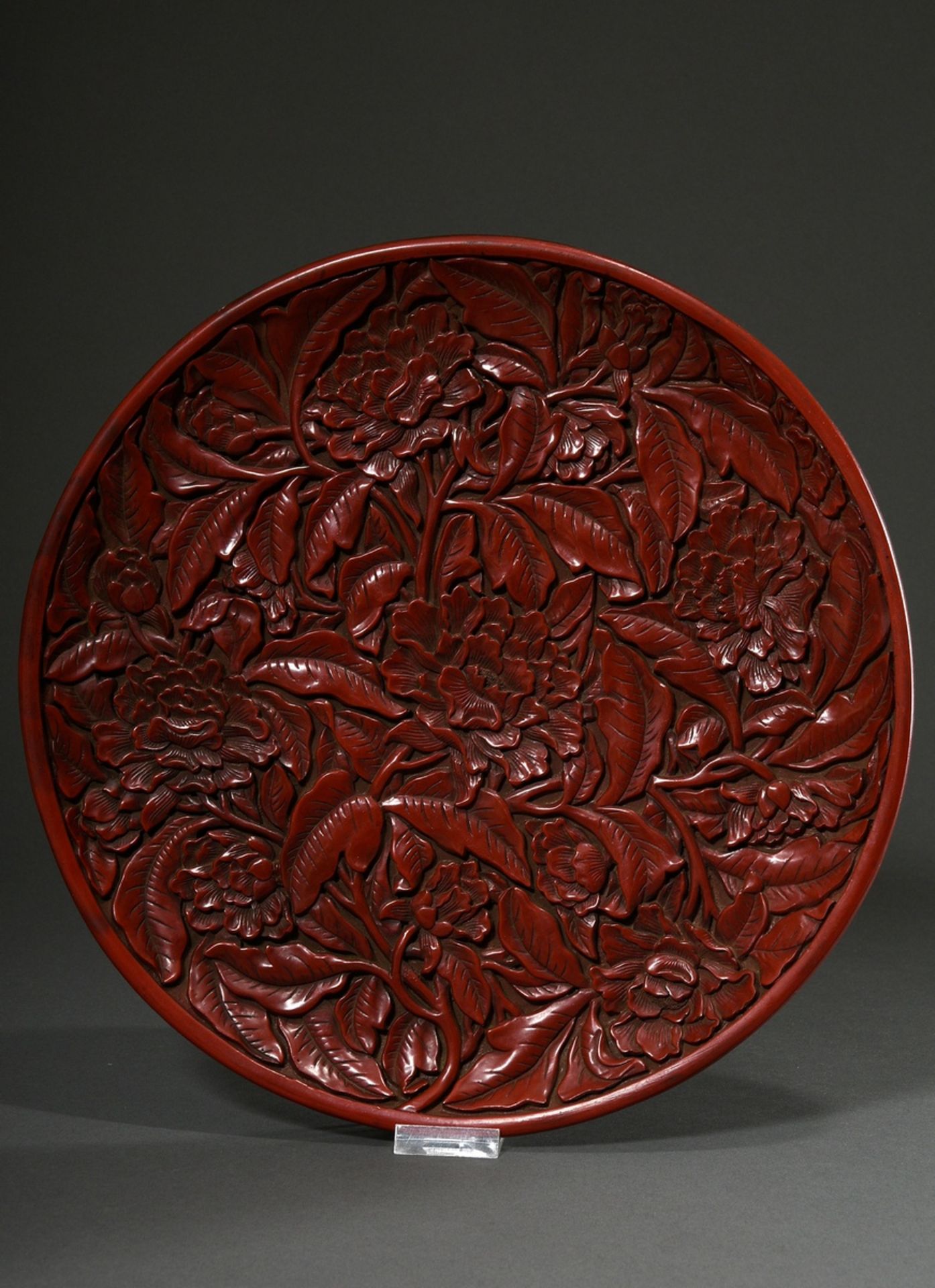 Red carved lacquer plate in the style of the early Ming period "Peonies", bottom with gold inscript